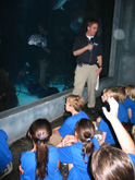 Aquarium expert teaching curious children